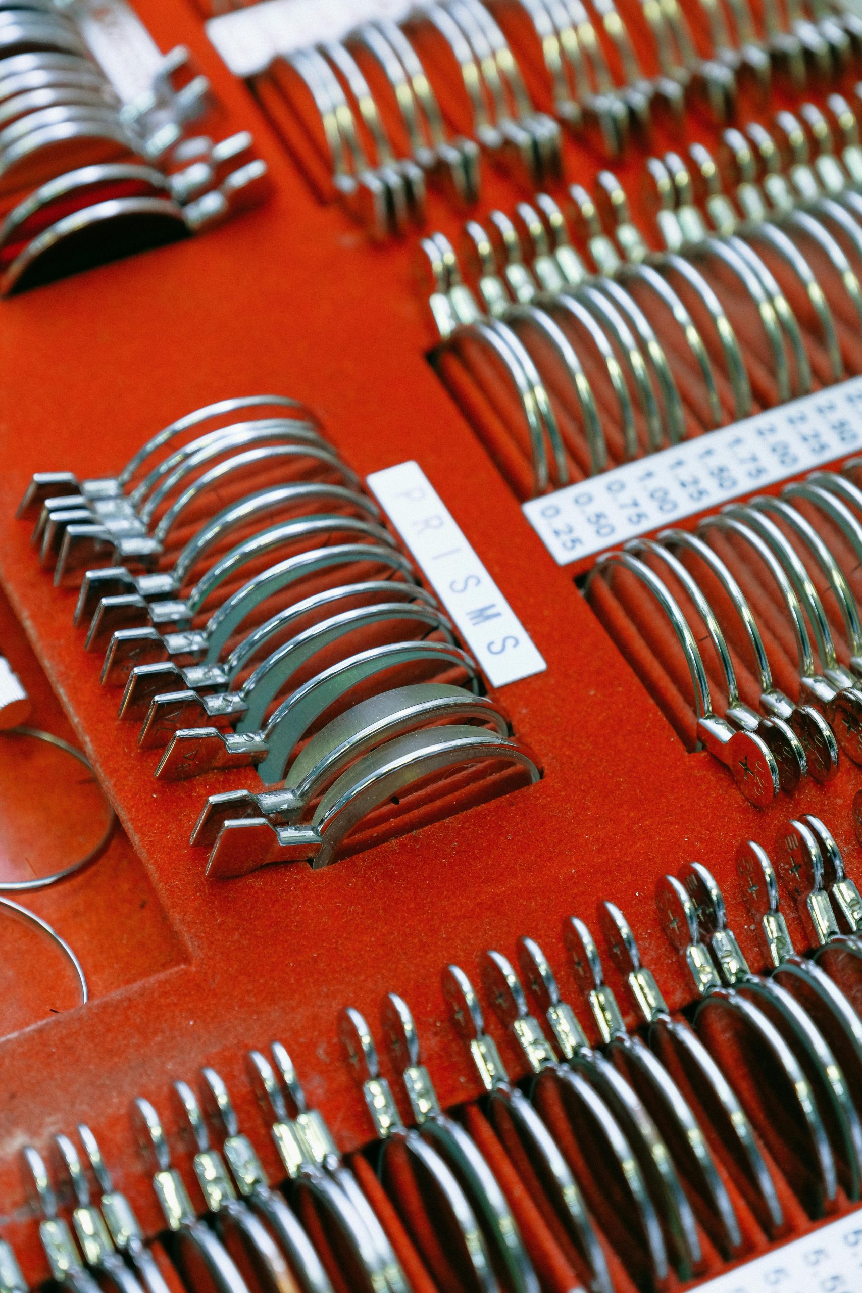 From above of soft red velvet surface with glasses set in row and scale with digits between