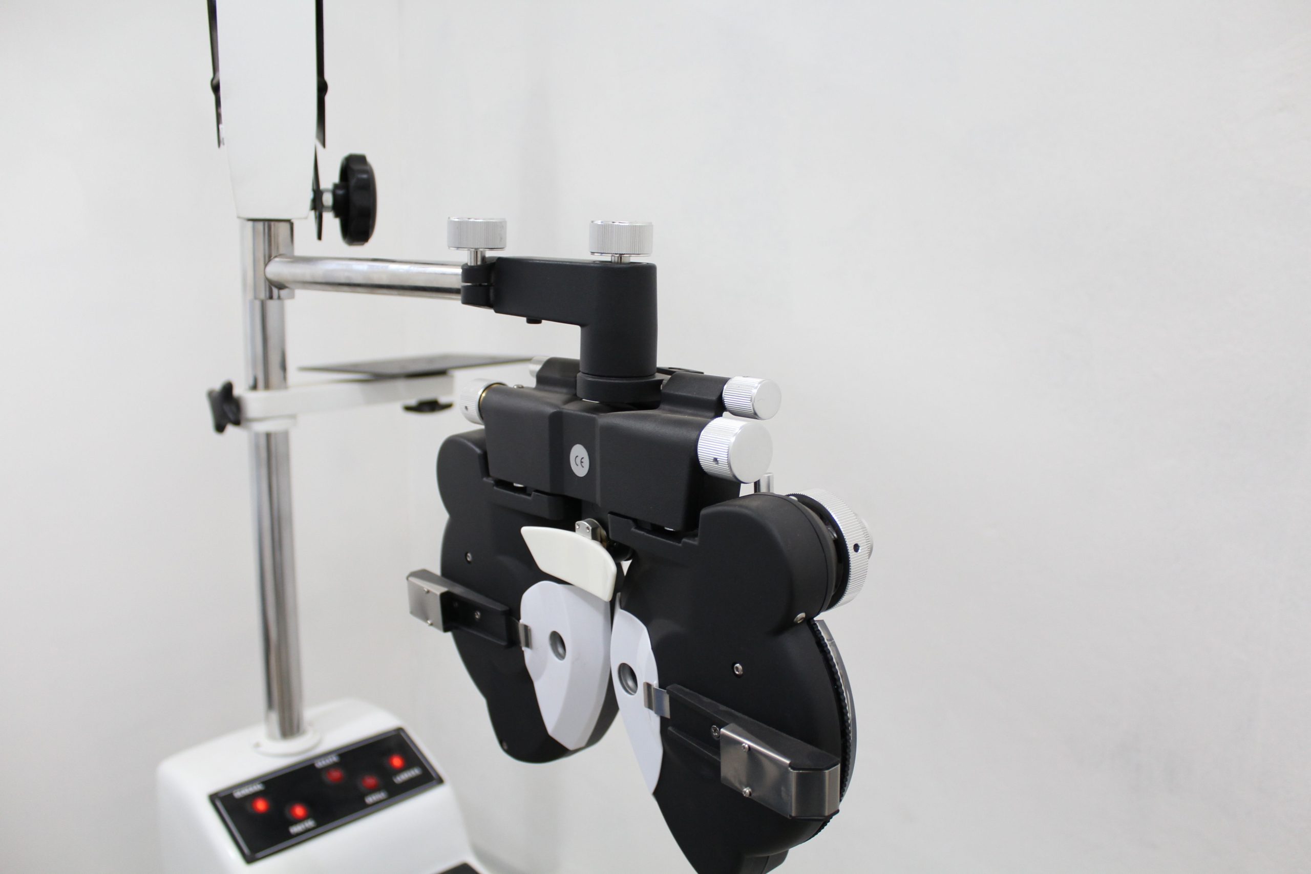 A phoropter used in optometry for eye examination in a bright medical office.